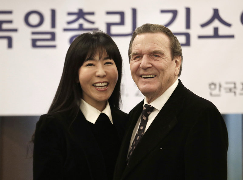 Former German Chancellor Gerhard Schroeder poses with his South Korean fiancee Kim So-yeon during a press conference in Seoul, South Korea, Thursday, Jan. 25, 2018. Yonhap News Agency said that they are going to marry around this autumn and that the exact venue and time have yet to be fixed. (AP Photo/Ahn Young-joon)