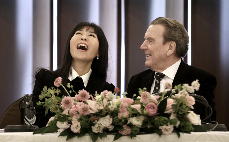 Former German Chancellor Gerhard Schroeder and his South Korean fiancee Kim So-yeon smile press conference in Seoul, South Korea, Thursday, Jan. 25, 2018. Yonhap News Agency said that they are going to marry around this autumn and that the exact venue and time have yet to be fixed. (AP Photo/Ahn Young-joon)