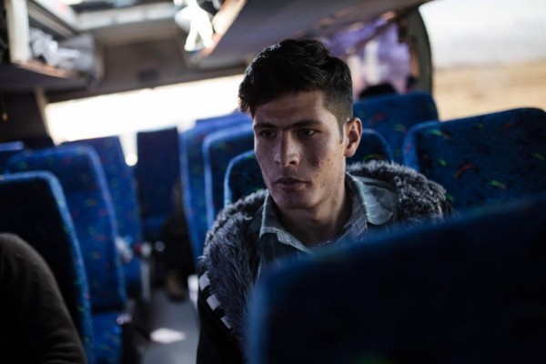Mukhtar (18) from Afghanistan following the interview waits inside a bus, in Idomeni, Greece on Feb.2, 2016.